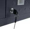 A close-up of a dark gray metal cabinet with a key in the lock. Voir les images du produit