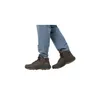A person wearing blue jeans and brown boots. Podgląd zdjęcia produktu