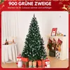 A decorated Christmas tree with gifts and stockings in a room setting. Anteprima dell’immagine prodotto