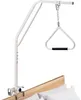 A white bed assist rail with a triangle handle is attached to the side of a bed. Náhľad obrázku produktu