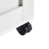A close-up view of a black caster wheel attached to the bottom of a white furniture piece. Anteprima dell’immagine prodotto