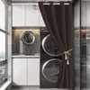 A laundry room with a stacked washer and dryer, a sink, and cabinets, partially obscured by a brown curtain. Produktbild-Vorschau