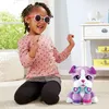 A young girl wearing sunglasses plays with a stuffed dog. Produktbild-Vorschau
