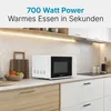 A white microwave oven is placed on a kitchen counter, with cabinets and lighting above. Produktbild-Vorschau