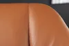 A close-up shot of the stitching and texture of a brown leather chair. Produktbild-Vorschau