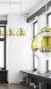 A modern interior scene with multiple pendant lights hanging from a white ceiling track. Produktbild-Vorschau