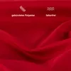 A close-up of red fabric with text and icons indicating product features. Produktbild-Vorschau