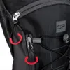Close-up of a black backpack with red zipper pulls and a gray logo. Produktbild-Vorschau