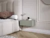 A bedroom scene with a bed, pillows, and a floating nightstand. Voir les images du produit