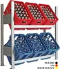 A two-tiered metal rack holding crates of beverages. The top tier has red crates filled with bottles, and the bottom tier has blue crates filled with plastic bottles. Produktbild-Vorschau