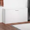 A white shoe cabinet with a single drawer handle, placed against a white wall on a wooden floor. Anteprima dell’immagine prodotto