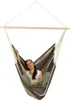 A woman is relaxing in a striped hammock chair. Produktbild-Vorschau