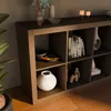 A bookshelf with various decorative items and books. Produktbild-Vorschau