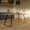 A dining table set in a modern kitchen environment with pendant lights overhead. Voir les images du produit