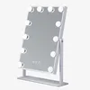 A white vanity mirror with LED lights and a stand, shown against a white background. Podgląd zdjęcia produktu