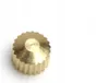 A close-up studio shot of a brass gear-like component. Produktbild-Vorschau