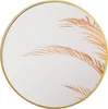 A round mirror with a gold frame, reflecting dried palm leaves. Náhled obrázku produktu