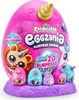 A large pink egg-shaped toy package with smaller eggs and characters displayed in front of it, all on a purple base. Náhled obrázku produktu
