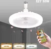 A ceiling fan light fixture with a remote control in hand. Voir les images du produit
