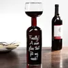 A novelty wine glass made from a wine bottle, with text on it, and a full bottle of wine in the background. Náhľad obrázku produktu