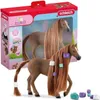 A toy horse with accessories in its packaging. Voir les images du produit