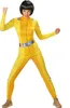 A woman in a yellow spy costume posing. Podgląd zdjęcia produktu