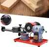 A close-up of a saw blade sharpener with wooden planks in the background. Náhled obrázku produktu