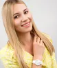 A woman wearing a yellow jacket and a white watch. Náhled obrázku produktu