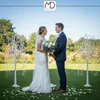 A wedding couple standing on a lawn with decorative trees. Podgląd zdjęcia produktu