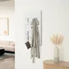 A hallway with a coat rack, sofa, and artwork. Anteprima dell’immagine prodotto