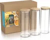 A cardboard box with a label showing pasta and storage jars, next to three glass storage jars with bamboo lids. Anteprima dell’immagine prodotto