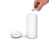 A hand is pouring liquid from a small bottle into a white aroma diffuser. Náhľad obrázku produktu