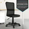 A black office chair is shown in a room with a desk and filing cabinet. Náhled obrázku produktu