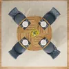 A top-down view of a round wooden dining table set for four, with chairs around it on a rug. Anteprima dell’immagine prodotto