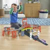 A young boy playing with a toy train set on a wooden floor. Náhľad obrázku produktu