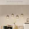 A modern dining room or kitchen setting with a chandelier hanging above a table. Podgląd zdjęcia produktu