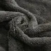 A close-up view of dark gray fluffy fabric, likely a blanket or throw. Produktbild-Vorschau