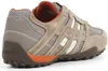 A side view of a single beige and brown Geox sneaker against a white background. Produktbild-Vorschau