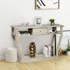 A console table with a drawer and shelf, decorated with various items. Podgląd zdjęcia produktu