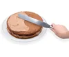 A hand is using a spatula to spread frosting on a cake. Produktbild-Vorschau