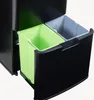 A close-up view of a black trash can with two pull-out compartments, one containing a green bin and the other a gray bin. Voir les images du produit