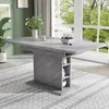 A dining table in a well-lit room with large windows. Produktbild-Vorschau