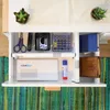 An overhead view of an open desk drawer filled with office supplies. Produktbild-Vorschau