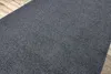 A close-up view of a gray carpet placed on a wooden floor. Produktbild-Vorschau