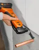 A person is using an oscillating multi-tool to cut a copper pipe. Náhľad obrázku produktu