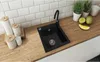 A kitchen sink area with a wooden countertop, white subway tile backsplash, and various kitchen accessories. Produktbild-Vorschau