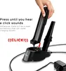 A hand is shown placing a handheld vacuum cleaner into its charging station. Produktbild-Vorschau