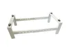 A white metal bracket for an air conditioning unit is shown against a white background. Náhľad obrázku produktu