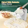 A white dumpling maker is shown with ingredients and finished dumplings. Text overlays describe its features. Produktbild-Vorschau