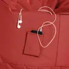 A close-up view of a red beanbag chair with a small pocket holding a smartphone and earbuds. Produktbild-Vorschau